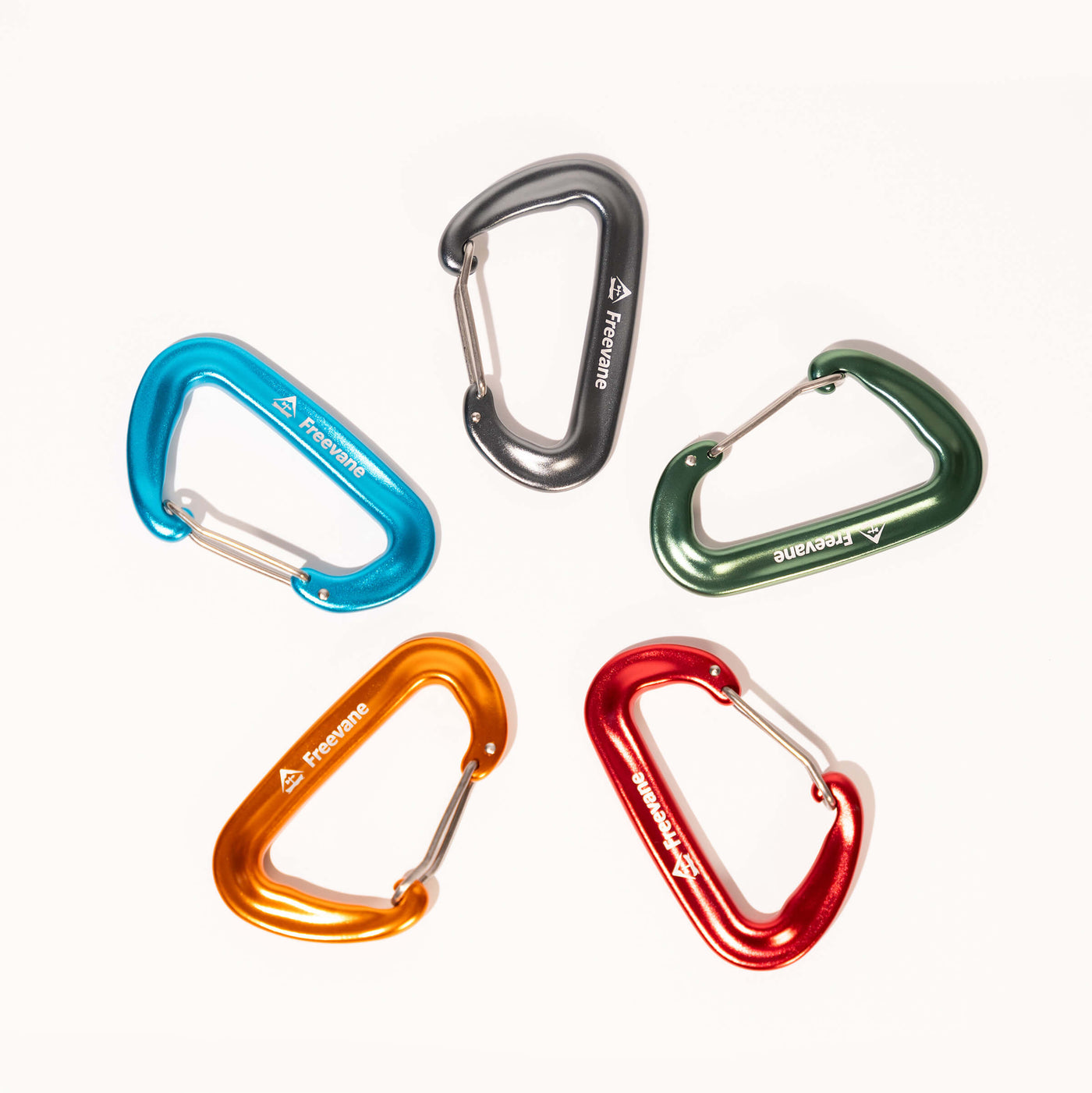 Five colorful wire gate carabiners on a white background