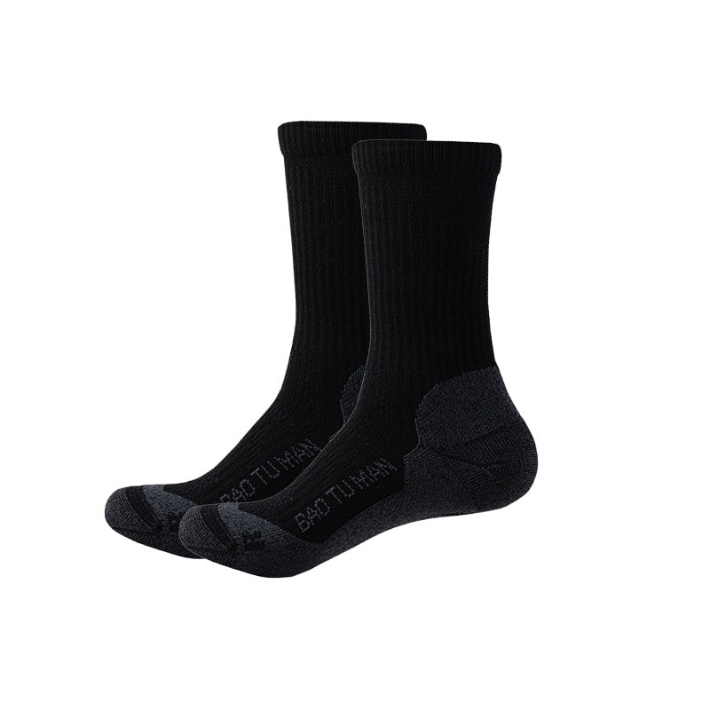 Black Merino wool hiking socks with cushioned soles, reinforced heels, and ribbed crew cuffs.
