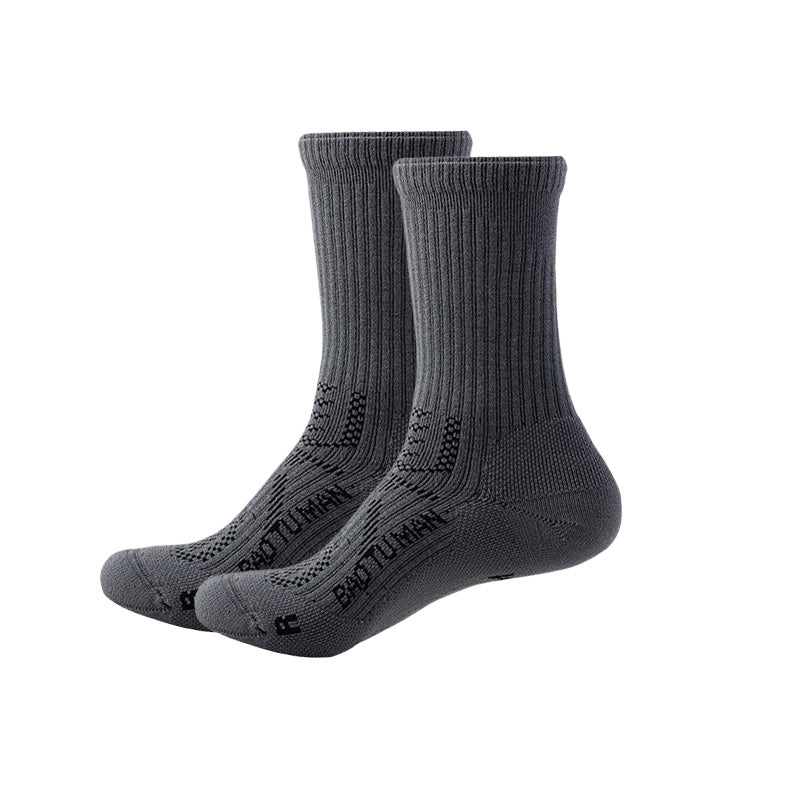 Dark gray Merino wool hiking socks with full-foot cushioning, arch support, and crew-height cuffs.